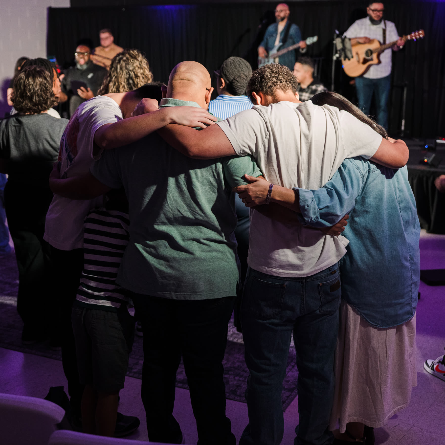 A small group praying together at Home Church